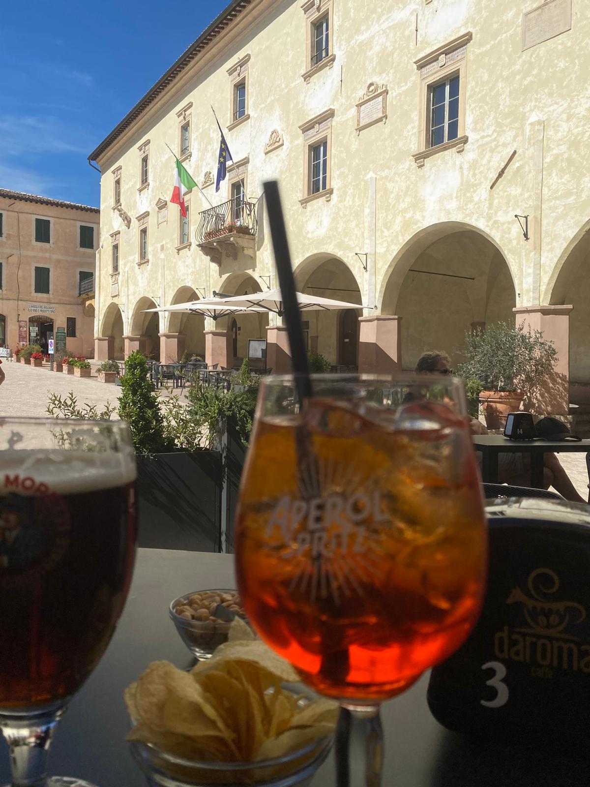 Glass of Aperol Spritz on a table at a historic bar in central Trevi, Umbria