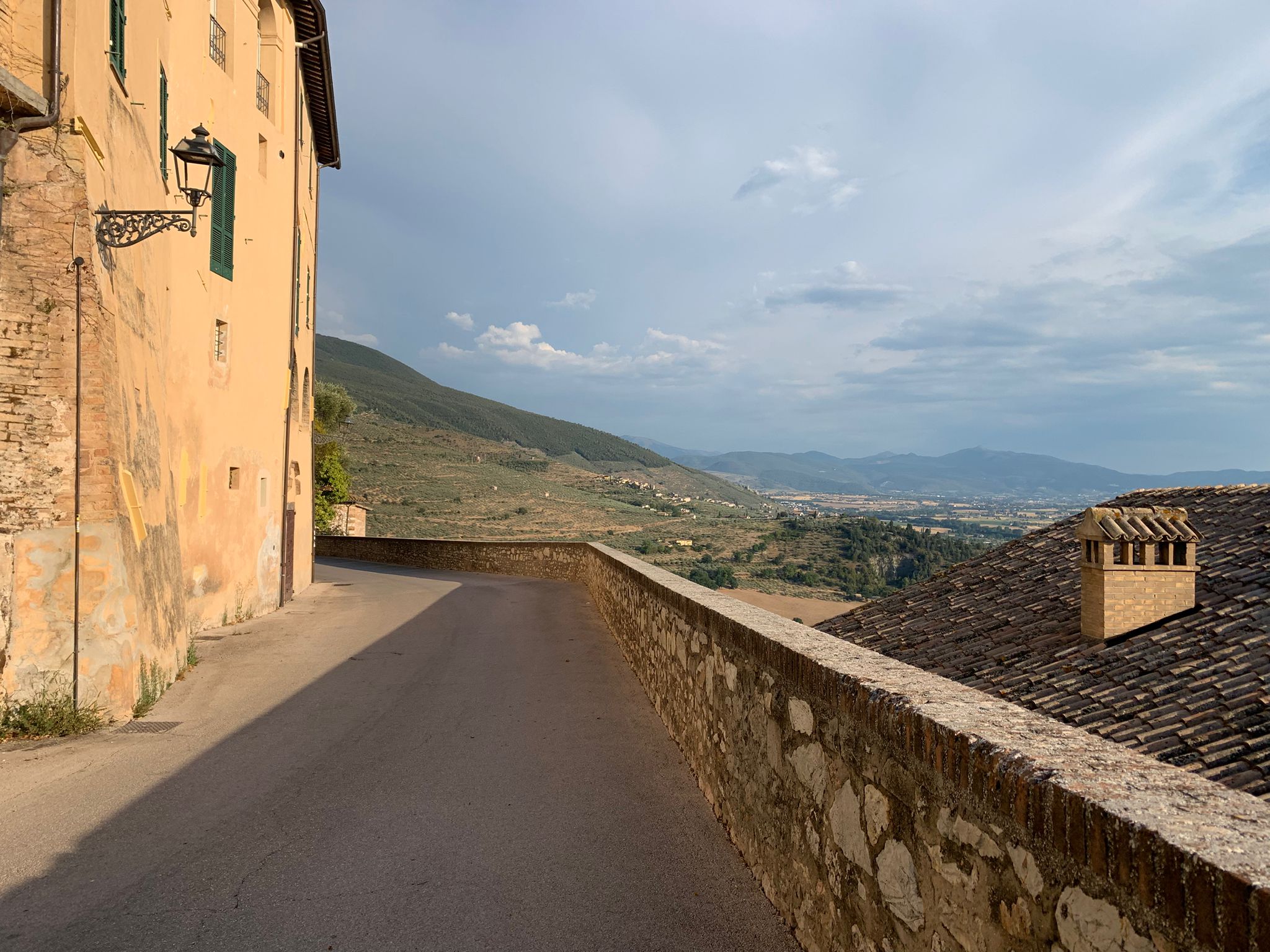 Wide view of the Umbrian hills seen from Trevi’s historic stone wall