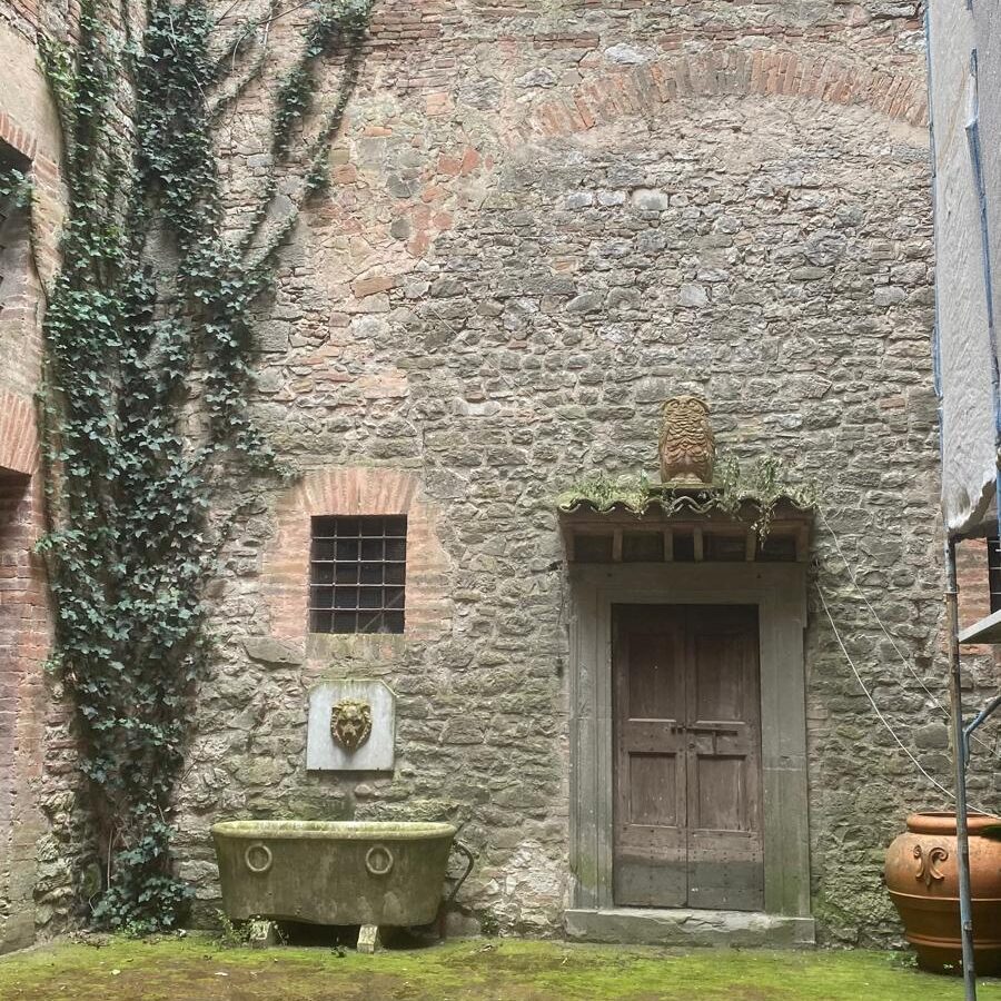 Quiet inner courtyard of a residential building in central Todi, Umbria