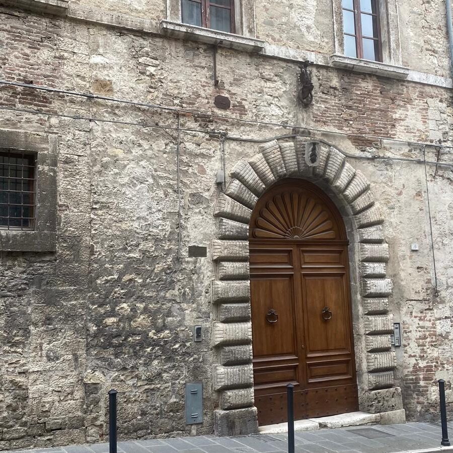 Close-up of an impressive historic door in Todi's old town, showcasing traditional Italian craftsmanshi