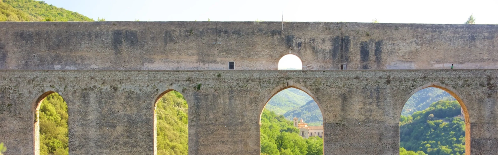 Ponte delle Torri in Spoleto, a tall medieval bridge overlooking the green Tessino valley and the Rocca Albornoziana fortress